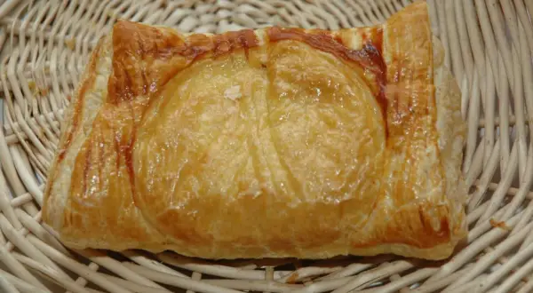 Un feuilleté de ris de veau doré et croustillant, présenté dans un panier en osier. Un délice à savourer.